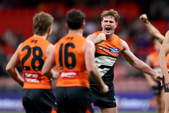 Giants teammates get around jubilant midfielder Tom Green.