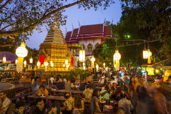 Crowds congregate on market night where many food stalls are set up within the temple courtyard.
