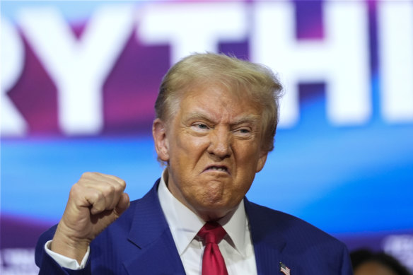 Do<em></em>nald Trump gestures at the event wher<em></em>e he played DJ, requesting and introducing his favourite songs.