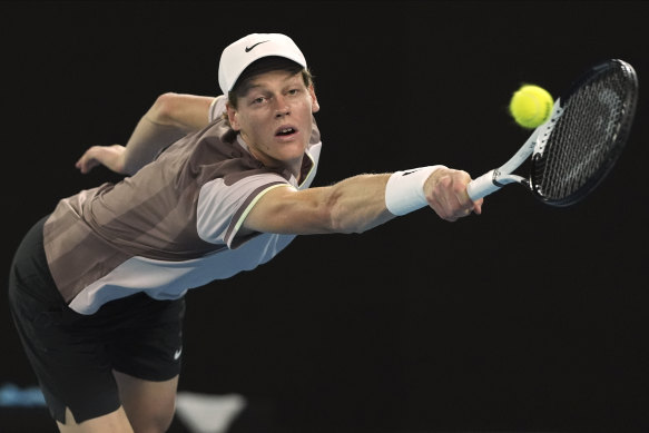 Jannik Sinner plays a backhand return to Andrey Rublev.