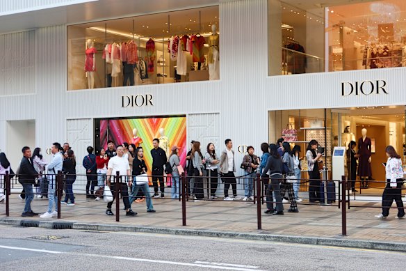 Customers queue to enter a Dior store in Hong Kong, perhaps in need of more handbags.
