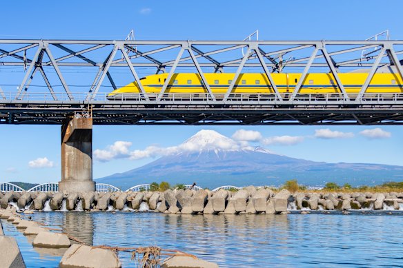 High-speed rail meets iconic scenery … The Doctor Yellow Shinkansen speeds past Mount Fuji.