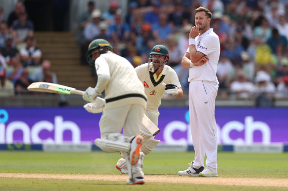 Ollie Robinson looks on as Travis Head and Usman Khawaja run between the wickets in the first Test at Edgbaston.