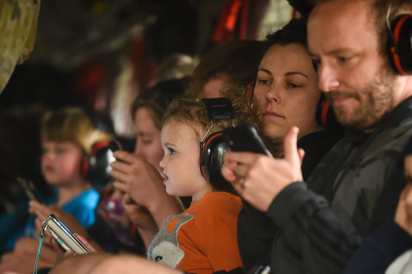 Families with small children onboard a Chinook helicopter are evacuated from Mallacoota.