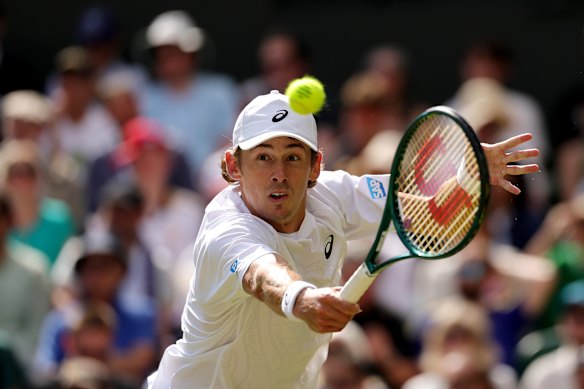 Alex de Minaur lunges for a backhand during his four-set defeat to Novak Djokovic.