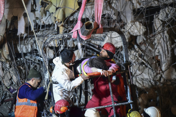Rescuers pull a woman from a collapsed building 87 hours after the quake hit in Kahramanmaras, southern Turkey.