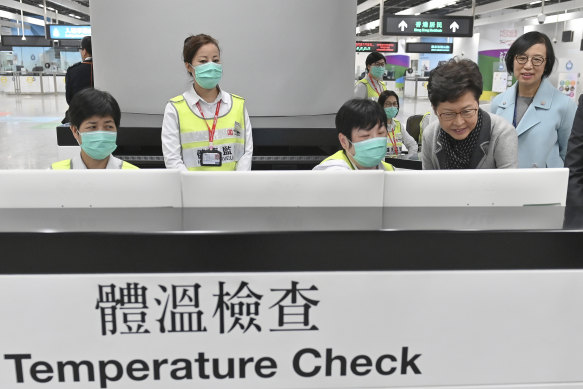 Chief Executive Carrie Lam, second from right, at the temperature check counter at West Kowloon Station in Hong Kong on January 3.