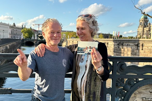 The writer, reunited with Martin in Berlin in 2025, holds a photo of the pair in 1990.