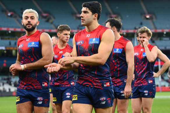Christian Salem and Christian Petracca and their Demons teammates look dejected after losing round 11. 