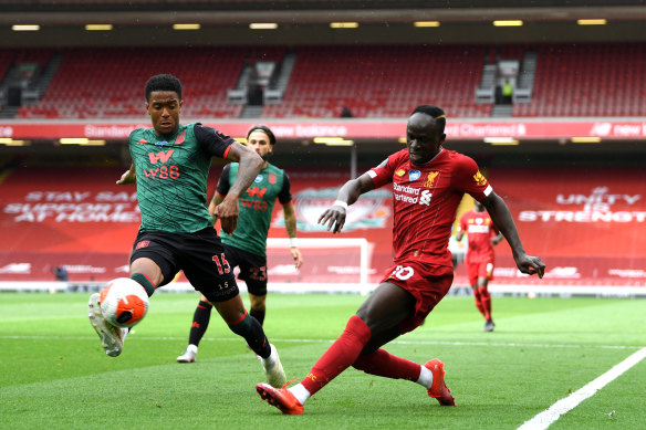 Liverpool's Sadio Mane – under pressure from Ezri Konsa of Aston Villa – crosses at Anfield on Sunday.