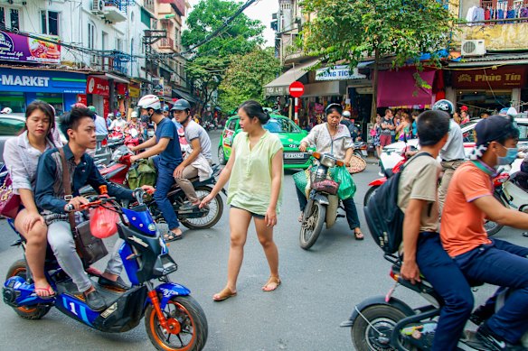 Crossing the road in Vietnam: slow and steady, never stop.