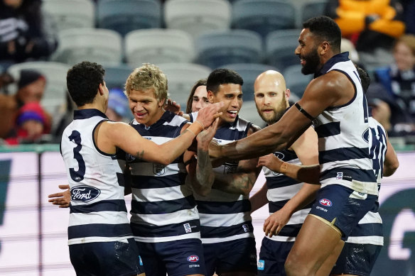 Quinton Narkle of the Cats celebrates with team-mates after kicking a goal against North. 
