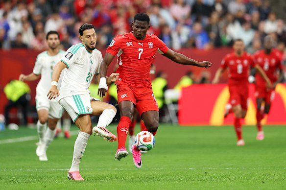 Breel Embolo #7 is challenged by Ramy Bensebaini #21.