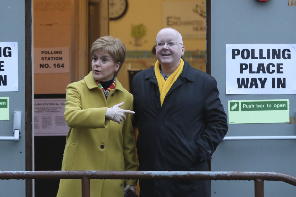 Then-Scottish first minister Nicola Sturgeon poses for the media with husband Peter Murrell outside a polling station in Glasgow in 2019.