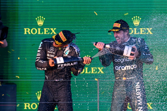 Max Verstappen celebrates his win at his year’s Australian Grand Prix with fellow driver Fernando Alonso.