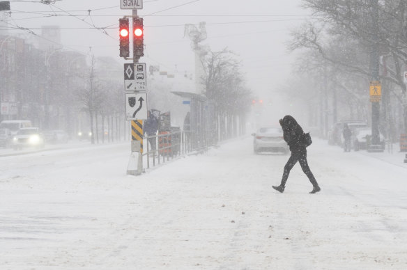 A person walks through blowing snow during a snowstorm in Toronto, Canada. 