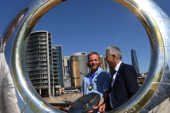 Rhyan Grant, Sydney FC coach Steve Corica, and the fruits of their A-League glory.