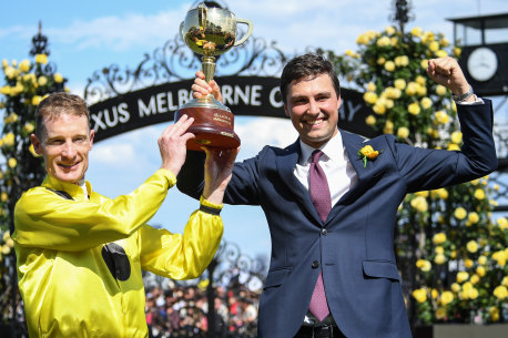 Winning jockey Mark Zahra and Sam Freedman with the Cup after Freedman and his father Anthony trained Without A Fight.