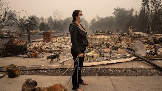 Lexi Sovllios from Talent, in Oregon, stands amid the ruins of her home.