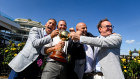 Racing’s gang of four celebrate their Melbourne Cup win. 