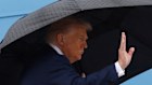 US President Donald Trump waves from the stairs of Air Force One as he boards at Joint Base Andrews for his trip to the Middle East.