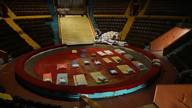 Mattresses line the floor of the Zaporizhzhia Circus ring preparing for people fleeing Mariupol. 