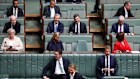 Angus Taylor (centre) sits during question time on Thursday.
