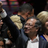 Former rebel Gustavo Petro and his wife Veronica Alcocer celebrate before supporters after winning a runoff presidential election in Bogota, Colombia.