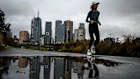 A jogger passes Melbourne’s CBD. Victoria is one of the most indebted states in the country, a situation that will worsen, S&P warns.