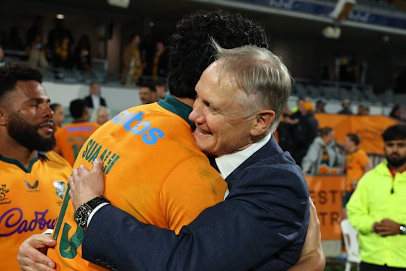 Joe Schmidt, head coach of the Wallabies hugs Joseph-Aukuso Suaalii after the Italy Test