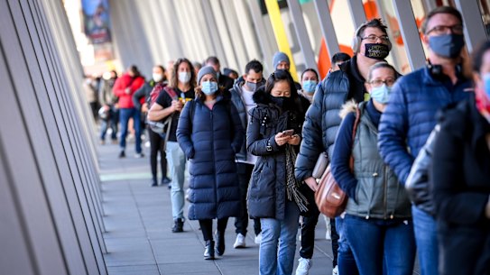 People queue up for COVID-19 vaccination at the Melbourne Convention and Exhibition Centre early on Wednesday morning.