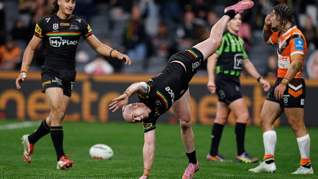 Dylan Edwards does a cartwheel after scoring a try.
