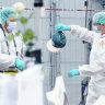 A forensic police officer work holds a cap at the scene of a knife attack at the market square in Mannheim, Germany.