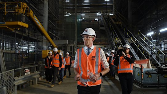 NSW Premier Dominic Perrottet walks through a Metro tunnel beneath Martin Place on Wednesday.