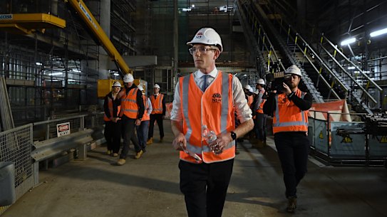 NSW Premier Dominic Perrottet walks through a Metro tunnel beneath Martin Place.