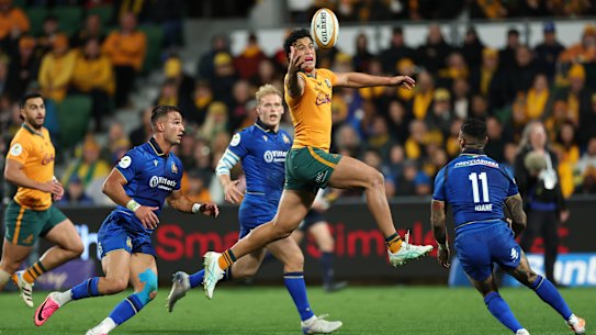 Joseph-Aukuso Suaalii of the Wallabies leaps for the ball against Italy.
