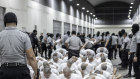 A prison guard transfers deportees from the US, alleged to be Venezuelan gang members, to the Terrorism Confinement Centre in Tecoluca, El Salvador. 