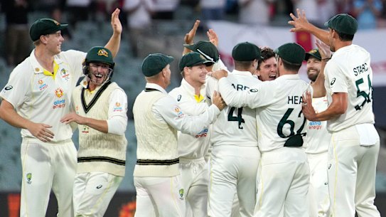Australia’s players celebrate the final wicket in Adelaide. 