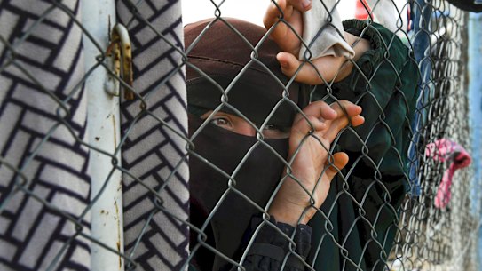A Foreign ISIS woman at the fence line of the Foreign section of Al Hawl camp.