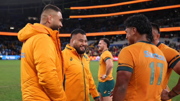 Taniela Tupou (centre) and teammates celebrate Australia’s win over Wales on Saturday night.