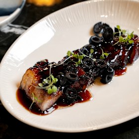 Caramelised pork belly with black olive.