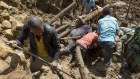  Villagers search through mud and rubble in Yambali village, in the Highlands of Papua New Guinea.