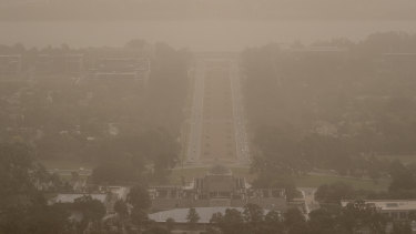 Wild winds dramatically reduced visibility in Canberra on Tuesday, blanketing Anzac Parade in dust. 