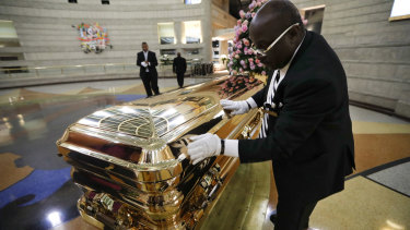 Vincent Street polishes the casket of the legendary Aretha Franklin.