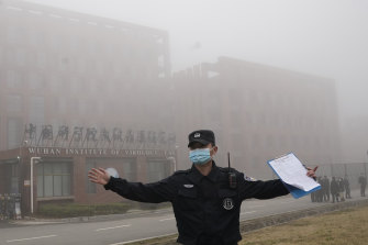 A security person moves journalists away from the Wuhan Institute of Virology in February after a World Health Organisation team arrived for a field visit in Wuhan in Chinaâ€™s Hubei province. 