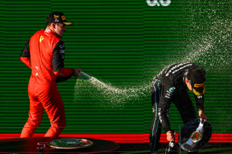 Charles Leclerc sprays George Russell, right, on the podium. 