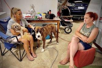 Chantelle Spinks (right) and Wendy, with dogs Teddy and Rocky, inside a shed at the Murwillumbah Showgrounds. 