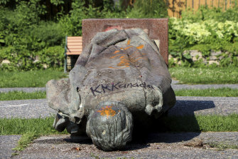 A statue of Queen Elizabeth II is seen overturned and vandalised in Winnipeg. 