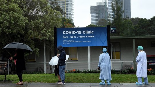 Health workers line up with the public at the coronavirus COVID-19 clinic at Concord Hospital on Wednesday.
