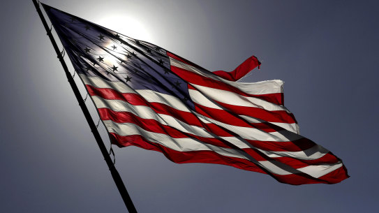 Strong winds from a cold front moving through Central Florida whip the massive American flag at Toyota of Orlando along Interstate 4, on the eve of the 2020 election.